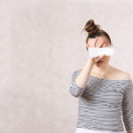 woman holding a panty liner in front of her eyes