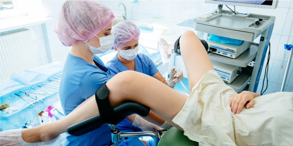 Doctors performing Hysteroscopy on a female
