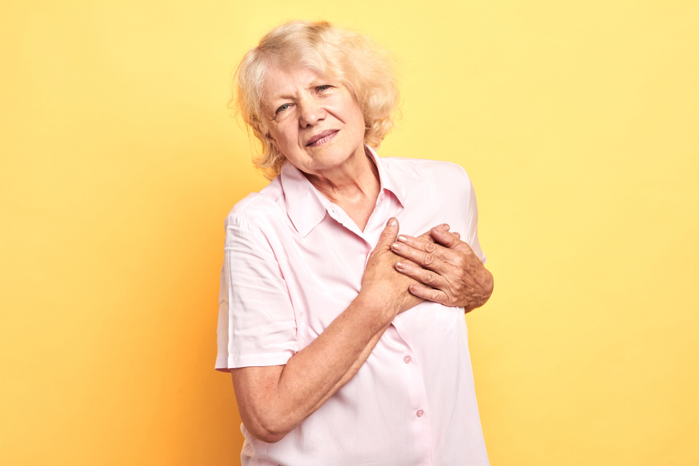 woman in pain with hand on the breast