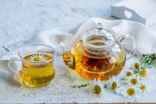 Chamomile Tea in a class cup and tea-pot