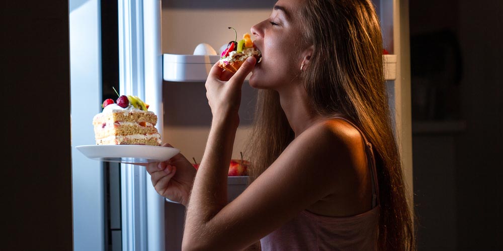 female with Candida infection binge eating deserts 