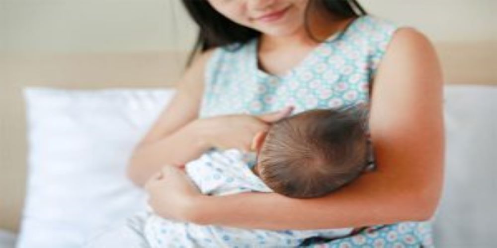 woman breast feeding the baby