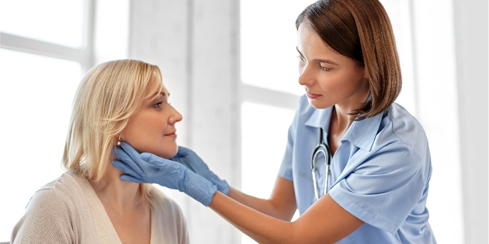 Doctor examining patient after tonsillectomy