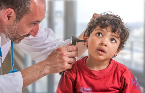 ENT doctor examining a child's ears