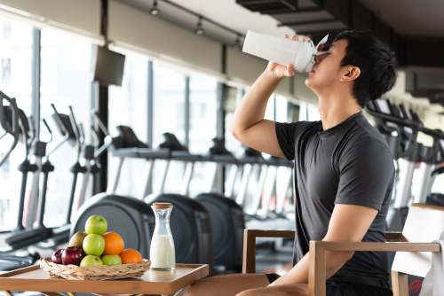 man eating healthy food and drinking milk