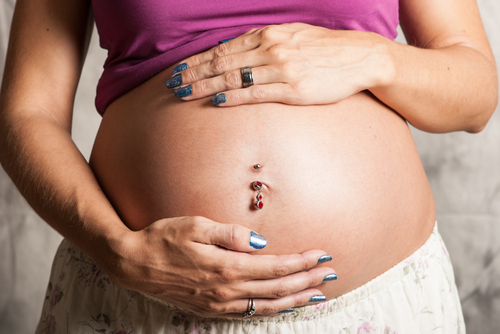 pregnant woman with belly piercing