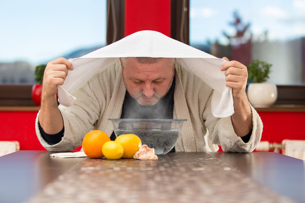 A man inhaling steam with face covered