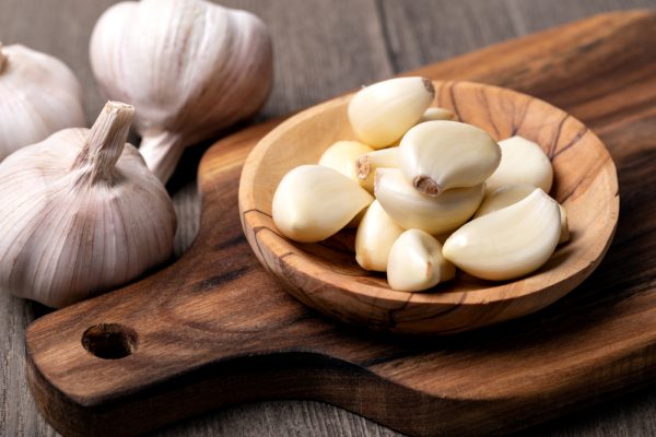 Garlic cloves in a wooden plate