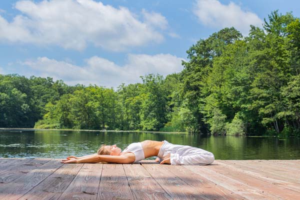 A girl performing Reclining Hero Pose