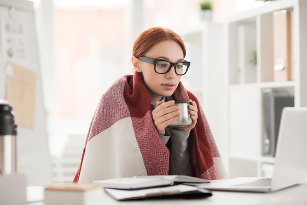 Woman with glasses drinking tea