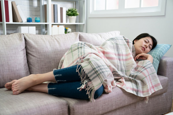 woman taking rest on couch