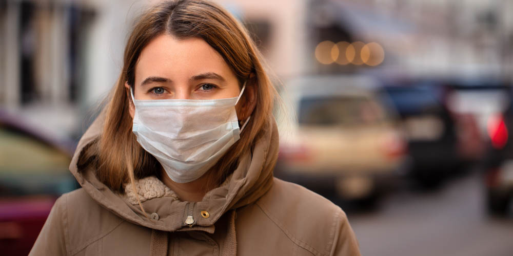 sick female wearing a mask