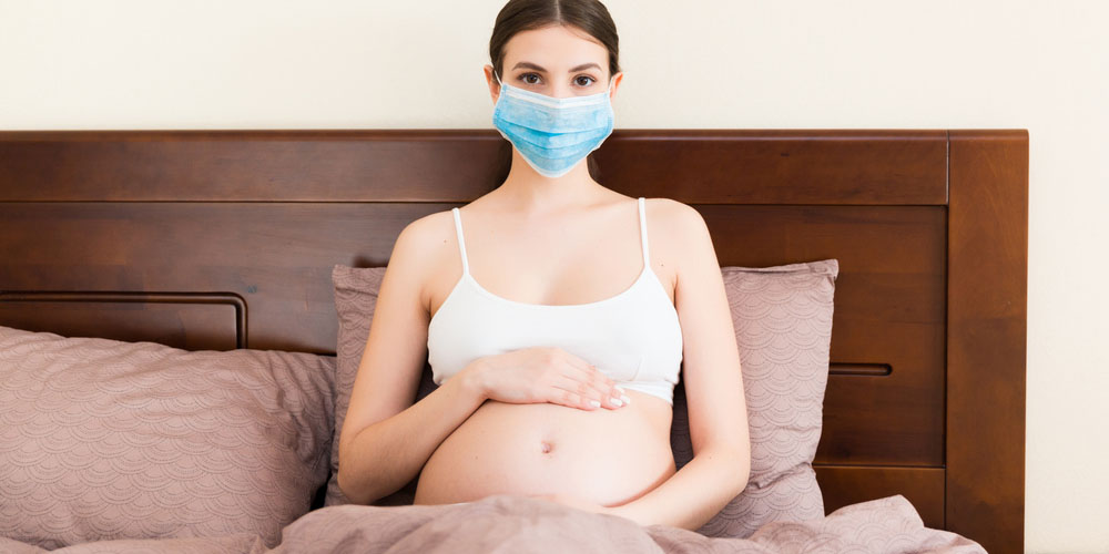 Pregnant female wearing a mask covering her mouth