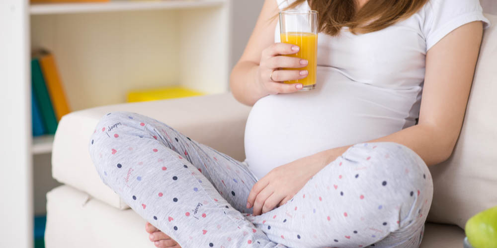 pregnant female drinking juice