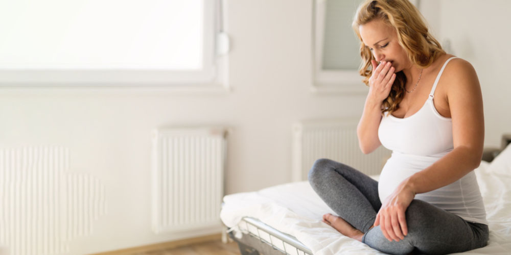 pregnant female having nausea