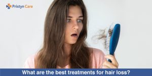 Girl looking at hair loss in comb