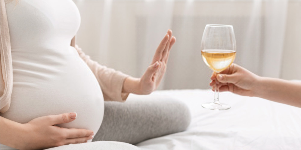 pregnant female saying no to alcohol