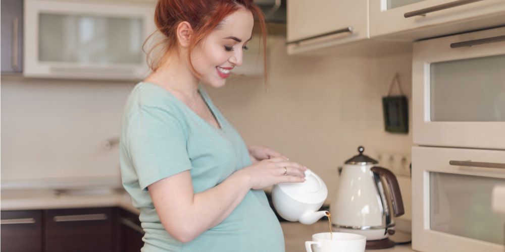 pregnant female drinking coffee