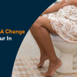 female sitting on toilet seat worried about change in urine coloraturas in pregnancy