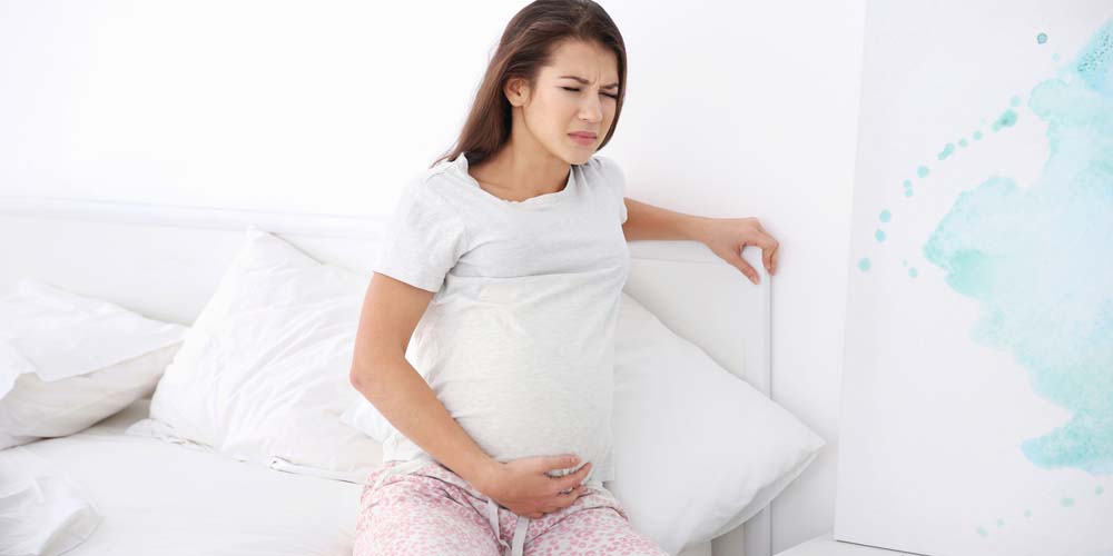 Young pregnant woman having pain