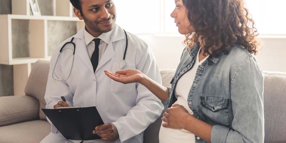 Pregnant Female holding Dolo 650 in her hand at doctor's office