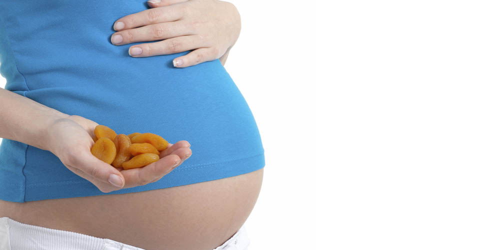 female eating dried apricots in pregnancy