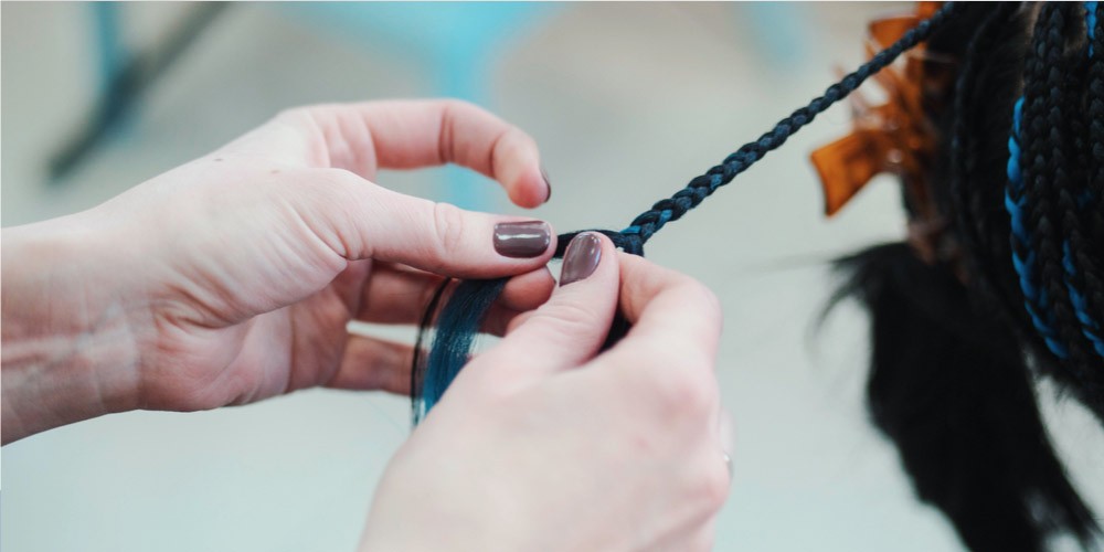 Girl braiding hair 