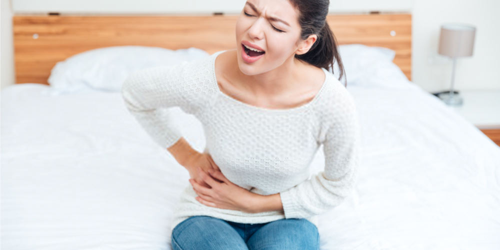 female suffering from kidney stone pain