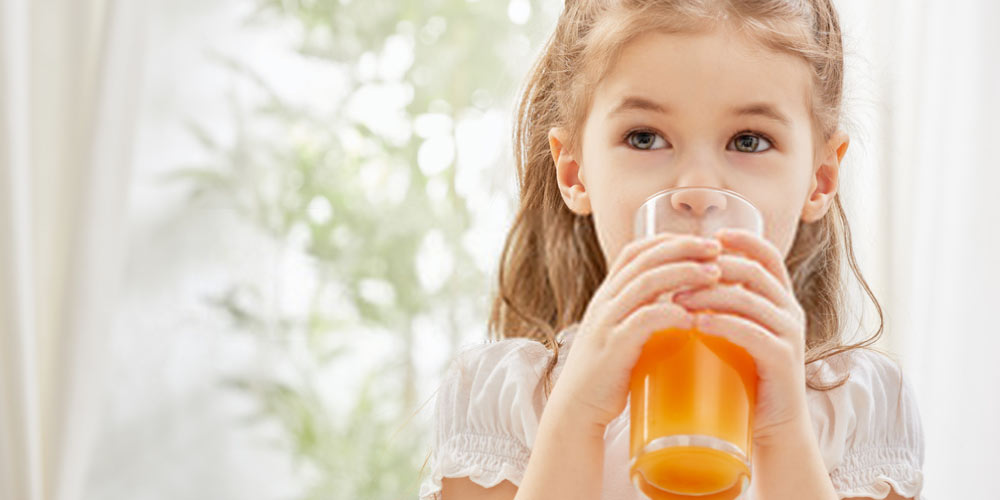 child drinking cold juice after tonsillectomy
