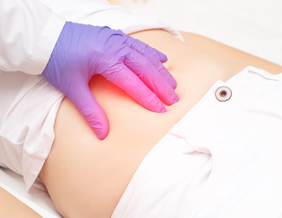 Doctor examining stomach of patient with abdominal pain