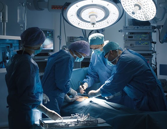 Doctors performing laser surgery for av fistula