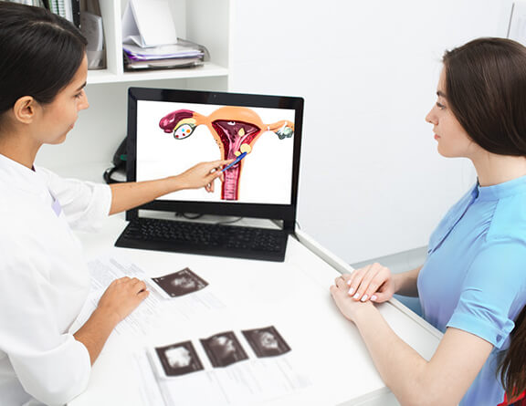 Gynecologist explaining about ovarian cysts to a female patient