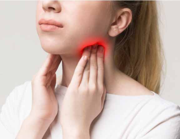 Female having sore throat due to tonsillitis