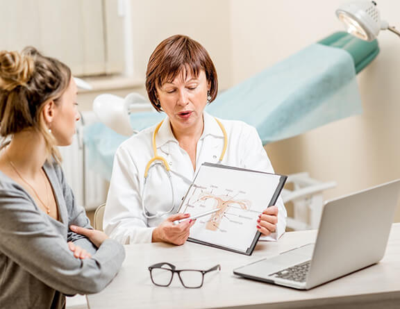 Female consulting gynecologist for vaginal discharge treatment