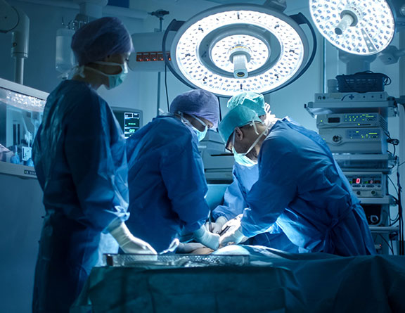 Surgeons performing varicocele surgery in operation theater