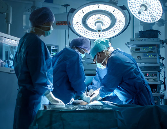 Doctors performing laser surgery for varicose veins