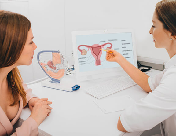 Female consulting gynecologist for pelvic pain treatment.
