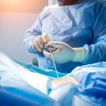 Surgeons performing spinal cord surgery on a patient 